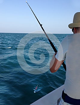 Young man fishing on a ocean