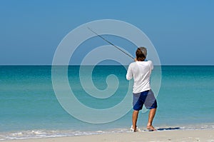 Young Man Fishing in Ocean