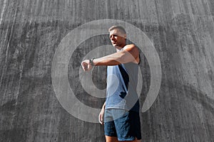 young man with fitness tracker on city street