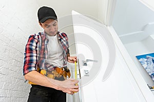 Young man fixing a door lock