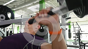 Young man flexing chest muscles on gym machine