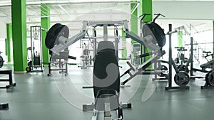 Young man flexing chest muscles on gym machine