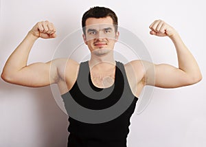 Young man flexing his muscles