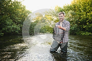 Young man flyfishing at sunrise