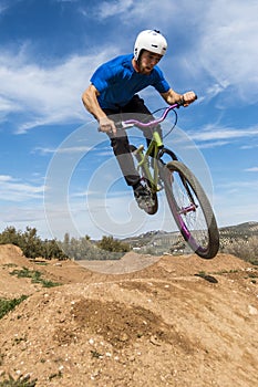 Young man flying on dirtjump bike