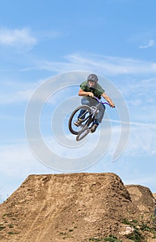 Young man flying on dirtjump bike