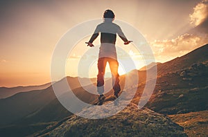 Young Man Flying levitation jumping in sunset mountains