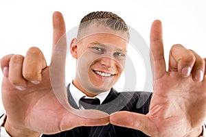 Young man framing his face with hand gesture