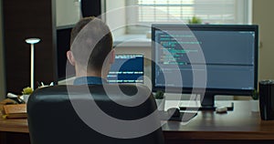 Young man freelancer coding html and programming on two screen Monitors, development web, developer.