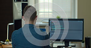 Young man freelancer coding html and programming on two screen Monitors, development web, developer.
