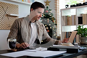 Young man freelancer working with computer laptop at home