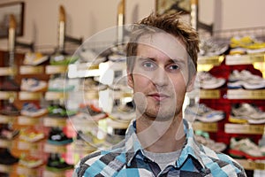 Young man in front of running shoes