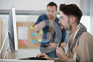 young man frowning while using computer