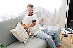 Young man with full beard chilling in his apatrment