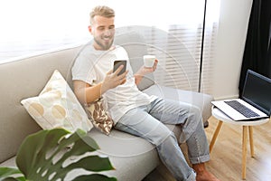 Young man with full beard chilling in his apatrment