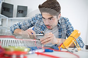 Young man on gas water heater reparation