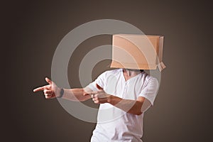 Young man gesturing with a cardboard box