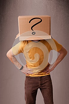 Young man gesturing with a cardboard box on his head