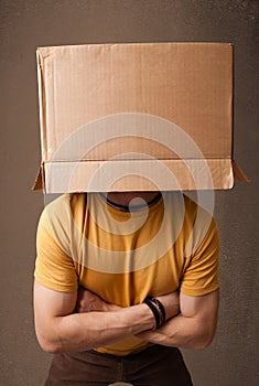 Young man gesturing with a cardboard box on his head