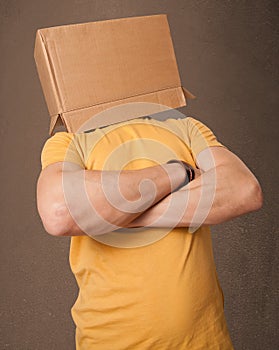 Young man gesturing with a cardboard box on his head