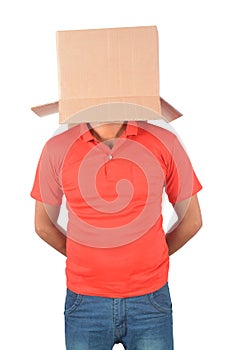 Young man gesturing with a cardboard box on his head isolated on