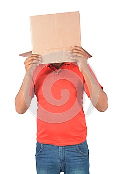 Young man gesturing with a cardboard box on his head isolated on