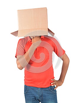 Young man gesturing with a cardboard box on his head isolated on