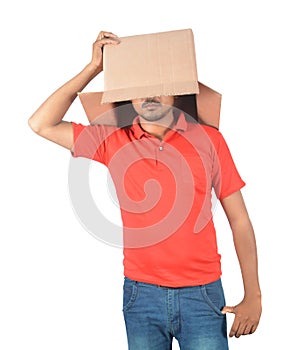 Young man gesturing with a cardboard box on his head isolated on