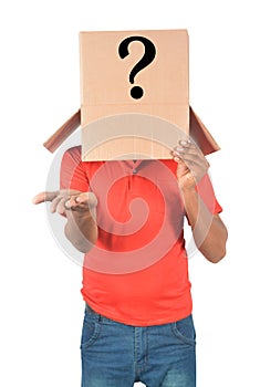 Young man gesturing with a cardboard box on his head with question mark isolated on white background