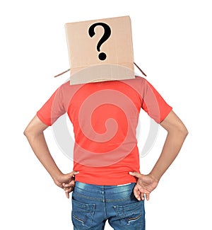 Young man gesturing with a cardboard box on his head with question mark isolated on white background