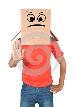 Young man gesturing with a cardboard box on his head with sad fa