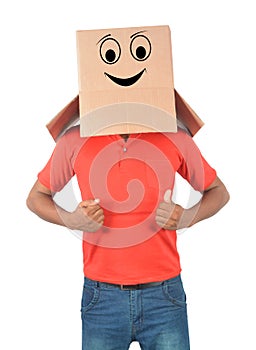 Young man gesturing with a cardboard box on his head with smiley