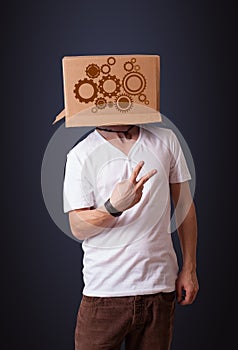 Young man gesturing with a cardboard box on his head with spur w