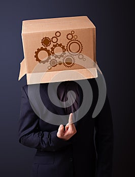 Young man gesturing with a cardboard box on his head with spur w