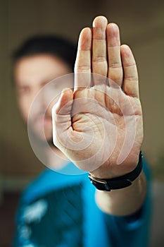 Young man gesturing stop with his hand