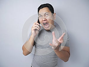 Young Man Getting Bad News on Phone, Shocked and Angry