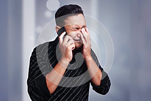 Young Man Getting Bad News on Phone, Shocked and Crying