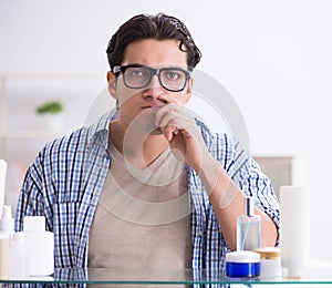 Young man is getting prepared for working day in bathroom