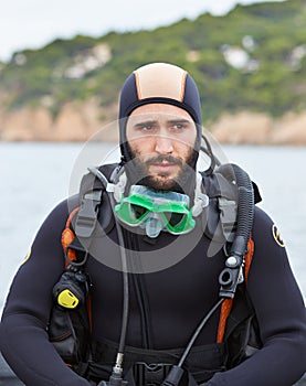 Young man getting ready for scuba diving