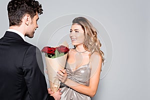 Young man gifting bouquet to woman