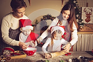 Young man and girl teach children how to cook cookies in the kitchen