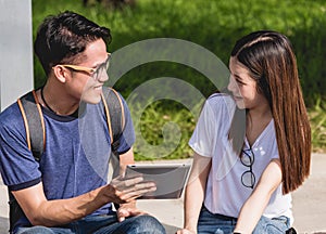 Young Man and girls friend classmates sitting consult