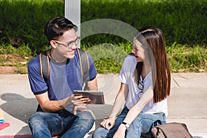 Young Man and girls friend classmates sitting consult