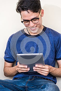 Young man and girls friend classmates sitting useing technology