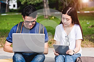 Young Man and girls friend sitting consult on laptop