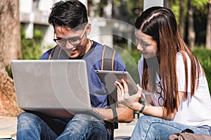 Young Man and girls friend sitting consult on laptop