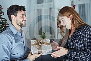 Young man give her girlfriend a present box