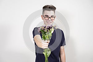 A young man gives a withered bouquet of flowers