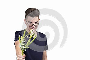 A young man gives a withered bouquet of flowers photo