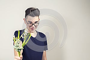 A young man gives a withered bouquet of flowers photo